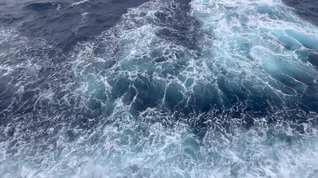 Atlantic Ocean waves from cruise ship deck near Bermuda &mdash; dark deep-sea water bursting into turquoise foam with each wave. Raw, unedited footage.