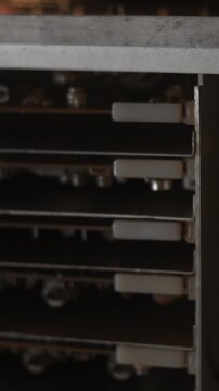 Power Supply Inspection. Detailed Examination Of Power Supply Unit Under Warm Lighting Conditions. Media