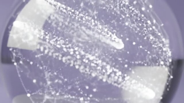 A camera zooms into a glass sphere on a white pedestal, showcasing a glowing, intricate swirl of light particles and plexus connections inside, then zooms out against a calm purple background.