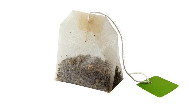 Single tea bag with green tag and string, isolated on transparent background