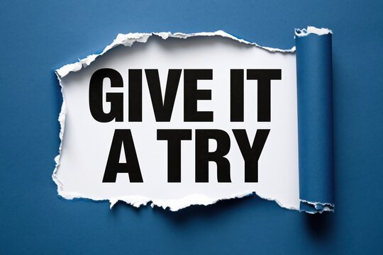 Motivational quote give it a try appearing under a dark blue torn paper texture