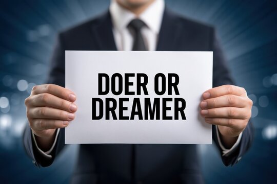 Business executive holding paper doer or dreamer text concept