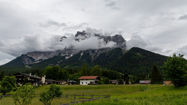 Tyrolean Alpine Village Meadow Below Cloudy Mountain Peaks