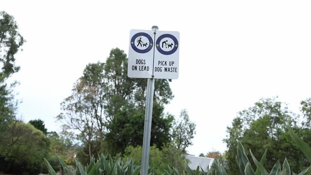 Park sign indicating dogs on lead and pick up waste rule