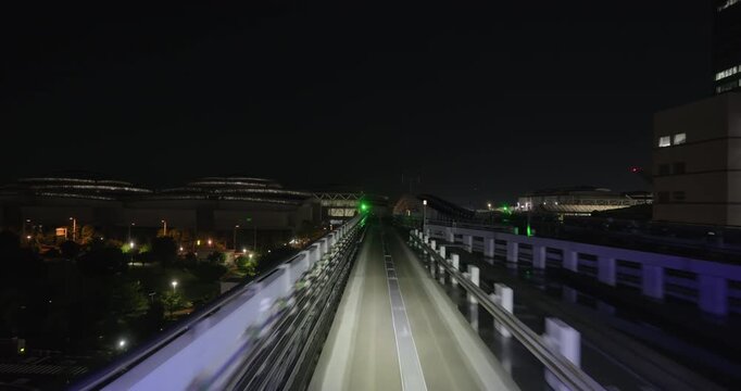 Train goes through city at night,  concept of speed