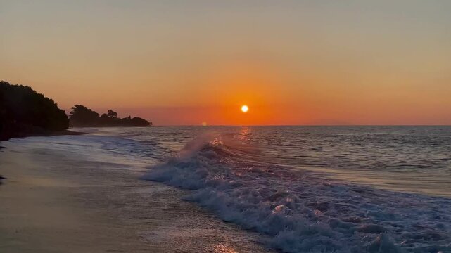 Horizontal wide shot of cinematic sunset beach with rolling ocean waves