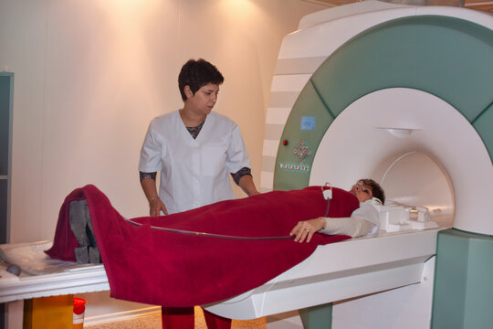 Magnetic resonance imaging scanner machine Technician preparing patient in modern hospital radiology room