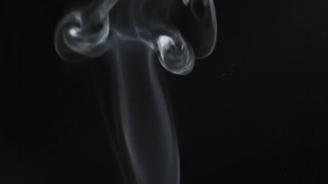 Thin wisp of white smoke rising and slowly dissolving into the air against a solid black background, featuring delicate textures and smooth movement for overlay or VFX compositing.
