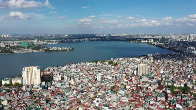 Aerial drone footage of Starlake Tay Ho Tay urban area and Ngoai Giao Doan (Diplomatic Corps Area) in Hanoi, Vietnam. Stunning bird's-eye view of modern residential towers, luxury apartments