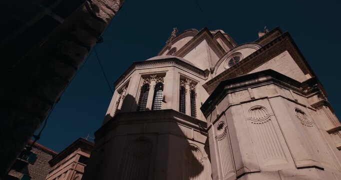 Low angle view of the apse, dome and exterior architecture of St James Cathedral in Sibenik Croatia.