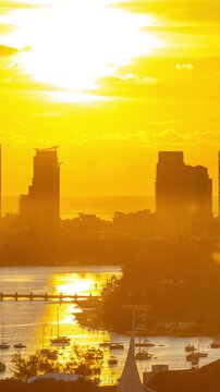 Time Lapse of the sun rising from behind the tall buildings on Miami Beach Florida. Vertical video.