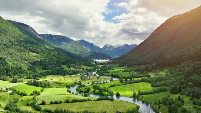 Aerial of a river winding through meadows and farmland near the town of Stryn Norway.