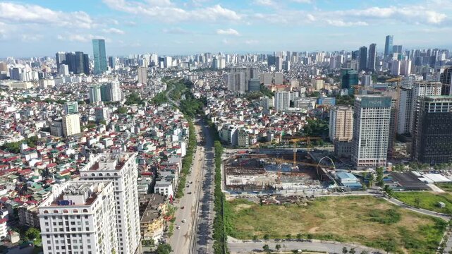 Aerial drone footage of Starlake Tay Ho Tay urban area and Ngoai Giao Doan (Diplomatic Corps Area) in Hanoi, Vietnam. Stunning bird's-eye view of modern residential towers, luxury apartments