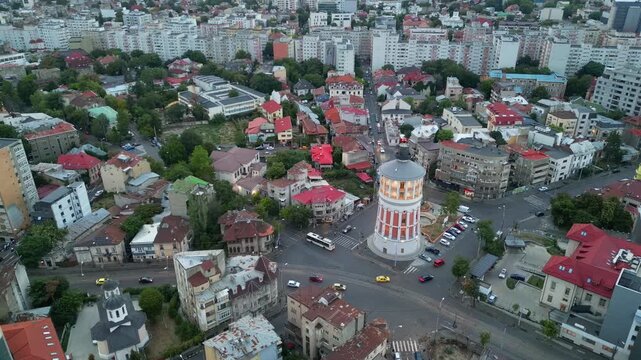 High angle daytime view of the historic Bucharest fire tower in Romania. Beautiful old circular brick architecture surrounded by urban city streets.