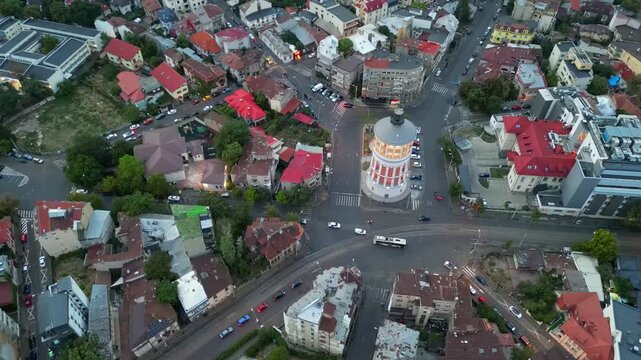 High angle daytime view of the historic Bucharest fire tower in Romania. Beautiful old circular brick architecture surrounded by urban city streets.