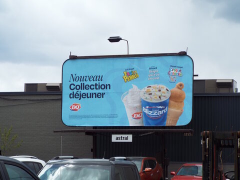 Gatineau, Quebec, Canada &ndash; May 8, 2026: A "Dairy Queen billboard" advertises a new breakfast collection featuring Fruity Pebbles Blizzard and Cinnamon Toast Crunch cones on Boul. Alexandre-Tach&eacute;.