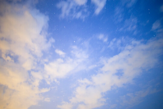 Starry Night Sky with Soft Clouds and Blue Twilight Atmosphere