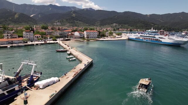 Aerial view of a small boat leaving the harbor of thassos town in greece