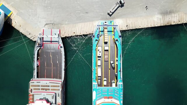 Aerial top view of a truck disembarking from ferry at the port