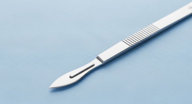 Surgical scalpel on a light blue textured fabric, medical instrument for precise cutting in surgery, sterile healthcare tool