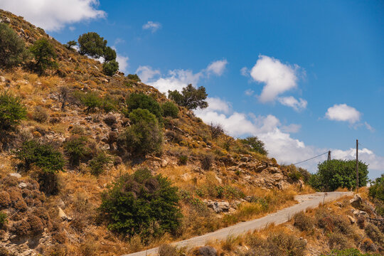 a narrow street running around the side of a mountain