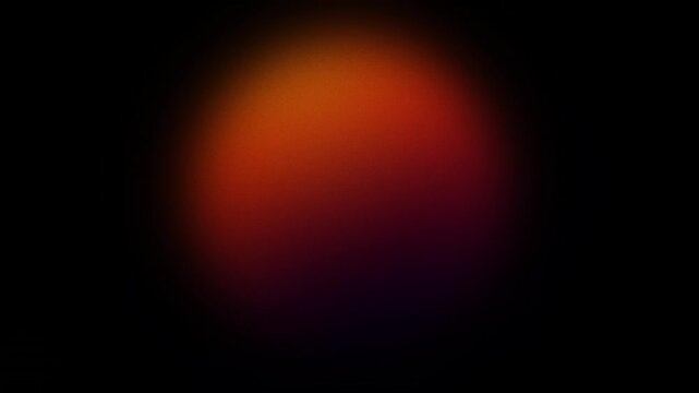 A dark background with a blurred, circular spotlight in red and orange hues.