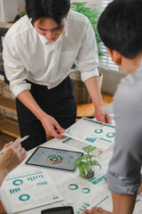 Fototapeta premium Business team reviewing sustainability data and environmental reports in a modern office meeting