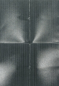 matte photo paper featuring a fine linear pattern, subtle crease folds, and soft reflected light across the textured surface.
