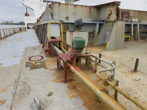 cargo ship pipes arrangement on deck and ventilation head of ballast tank. red fire hydrant from main fire line.