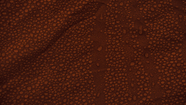 Water drops on waterproof brown fabric texture background. Condensation on synthetic material of outdoor rain jacket.