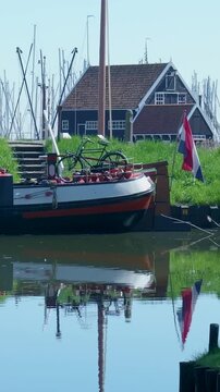 Dutch harbor with a bicycle on a boat and a flag waving in the wind