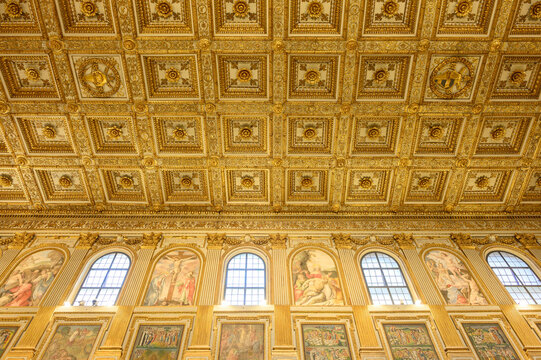 Santa Maria Maggiore basilica central nave interior view, Rome Italy. Golden coffered ceiling ancient columns and mosaics landmark perspective
