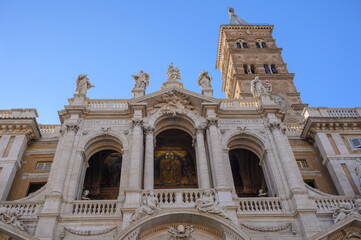 Obraz premium Baroque facade and medieval brick bell tower of the Basilica of Saint Mary Major in Rome, Italy
