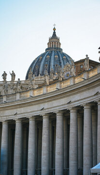 saint peter basilica​ VATICAN CITY, VATICAN - OCTOBER 16, 2025: Architectural detail of St. Peter's Basilica dome rising behind Bernini's colonnade columns