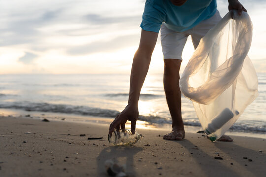 Save water. Volunteer pick up trash garbage at the beach and plastic bottles are difficult decompose prevent harm aquatic life. Earth, Environment, Greening planet, reduce global warming, Save world