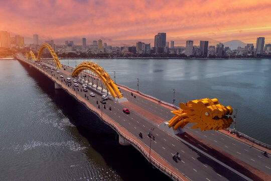 View of Dragon Bridge at sunset, golden hour, beautiful clouds with warm tint aerial view in the evening at sunset