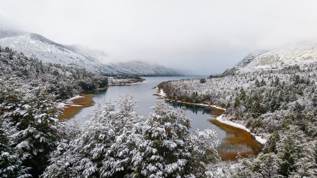 Snowy lake and forest landscape in the Patagonian Andes of Argentina.
