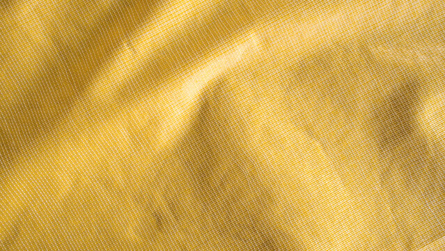Back view of yellow waterproof raincoat fabric texture with protective crumpled nylon material