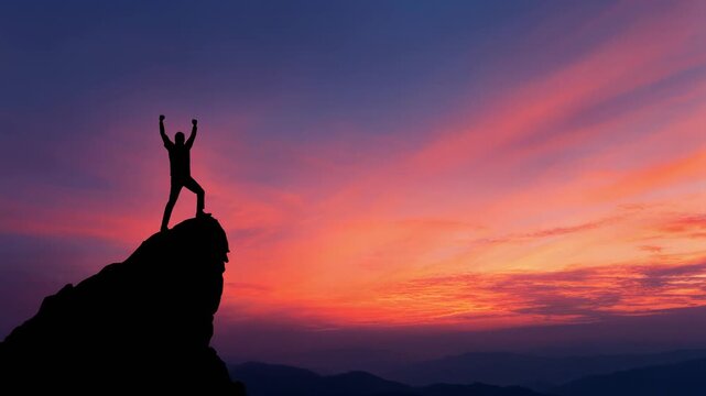 Silhouette of a person celebrating victory on a mountain peak during vibrant sunrise outdoor adventure