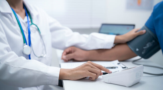 Blood pressure monitoring and patient examination in healthcare clinic with medical professional measuring vital signs for cardiovascular assessment preventive care wellness screening and diagnosis
