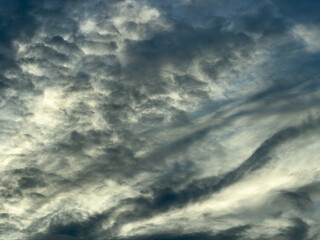 Obraz premium Dynamic evening cloudscape at golden hour on the first official day (June 1) of Atlantic hurricane season in southwest Florida. Motifs of wind flow and changeability.