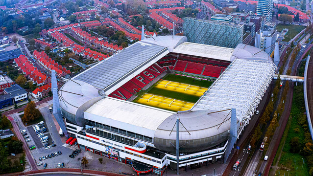 Aerial drone view of Philips Stadion, home of PSV Eindhoven, grow lights illuminating the pitch, Eindhoven, Netherlands, autumn