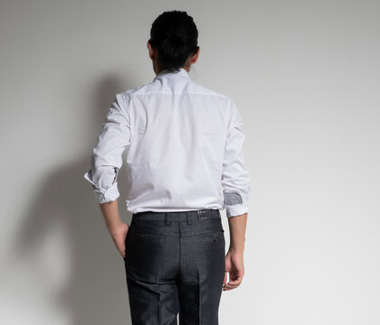 Studio portrait of an Asian man wearing a white shirt.