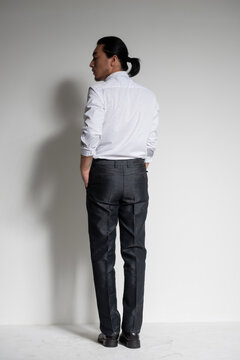 Studio portrait of an Asian man wearing a white shirt.