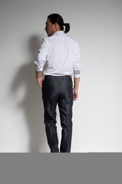 Studio portrait of an Asian man wearing a white shirt.