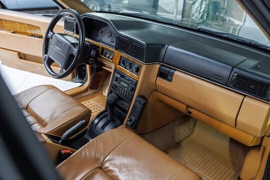 Interior of a Volvo 940 featuring brown leather seats and dashboard details