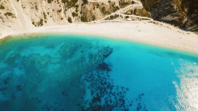 Turquoise shallow water and sandy shore at Myrtos Beach on Kefalonia island