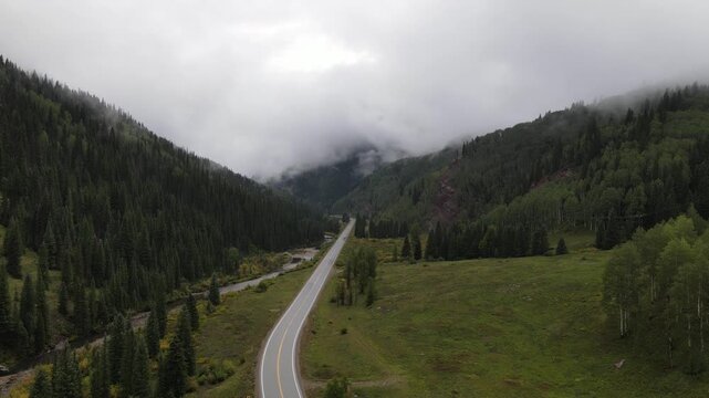 Drone shot ascending vertically over the Million Dollar Highway in Colorado on a foggy, rainy day. Perfect for reverse landing effects. 1080p 30fps.