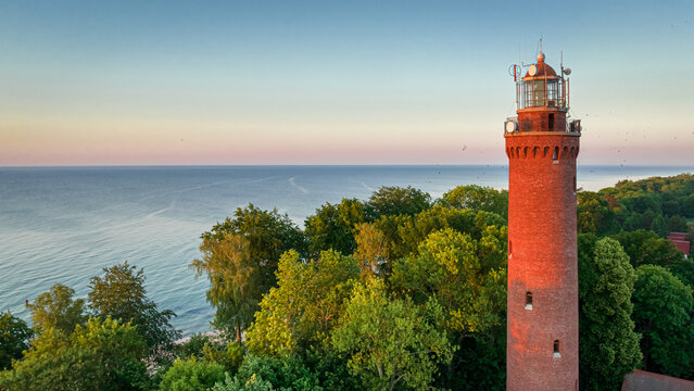 Lighthouse by Baltic sea at sunrise in Poland.