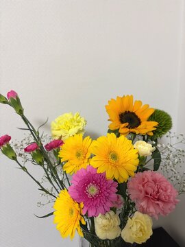Colorful summer bouquet sunflower yellow gerbera pink wide angle view white background